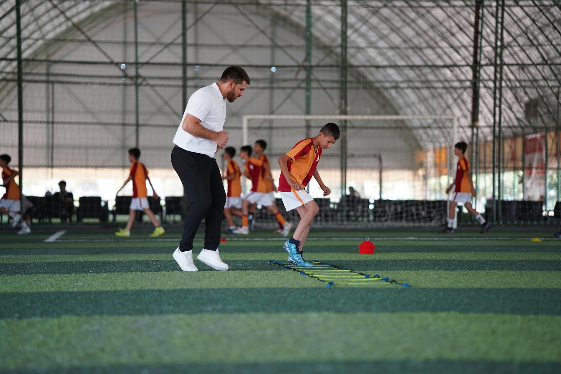 teenage soccer athlete doing agility ladder drills training