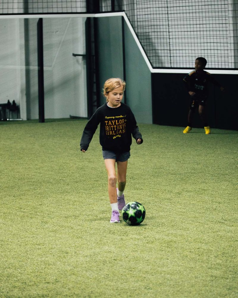 Young athlete training on the turf inside the Prestige Indoor Sports facility